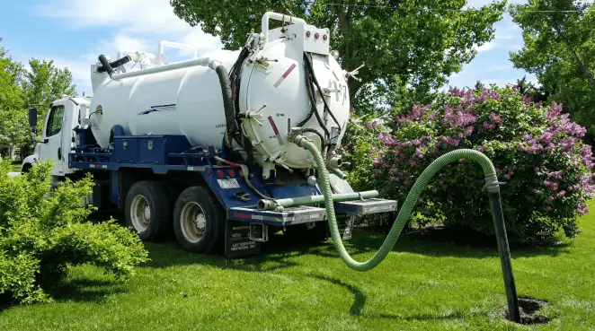 Professional vacuum truck performing residential drainage and septic maintenance in Boulder, CO