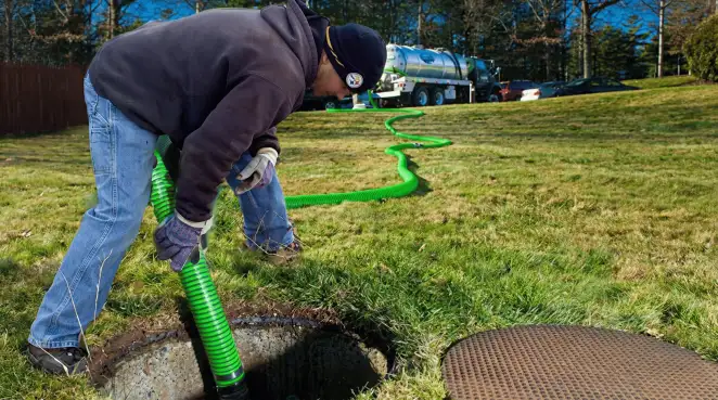 Service technician performing residential septic pumping and drainage maintenance in Boulder, CO